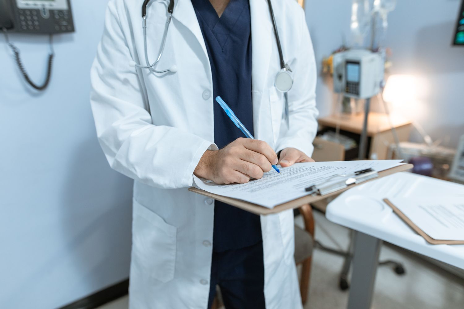 Real photograph of a clinician reviewing a medical chart